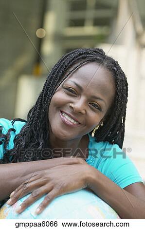 African woman leaning on globe View Large Photo Image Stock Photograph - African woman leaning on globe. Fotosearch