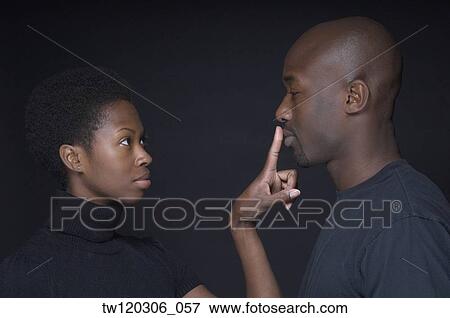 African woman putting finger on boyfriend’s lips View Large Photo Image Stock Photo - African woman putting finger on boyfriend’s lips. Fotosearch