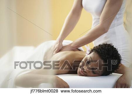 Stock Photo - African woman receiving massage. Fotosearch