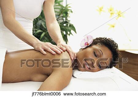 Stock Photograph - African woman receiving massage. Fotosearch