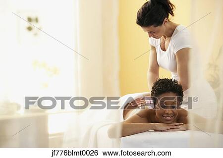 Stock Photograph - African woman receiving massage. Fotosearch
