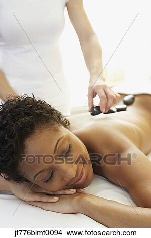 Picture - African woman receiving spa treatment. Fotosearch
