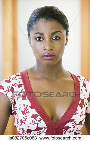 Stock Image - African woman wearing v neck blouse. Fotosearch