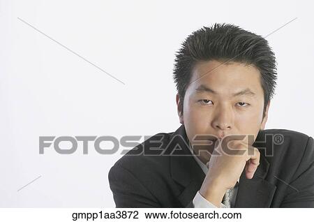 Asian businessman resting chin on hand View Large Photo Image Stock Image - Asian businessman resting chin on hand. Fotosearch