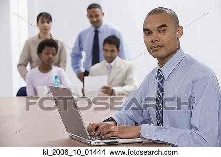 Asian businessman typing on laptop View Large Photo Image Picture - Asian businessman typing on laptop. Fotosearch
