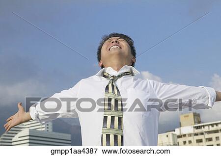 Asian businessman with arms outstretched View Large Photo Image Stock Photo - Asian businessman with arms outstretched. Fotosearch