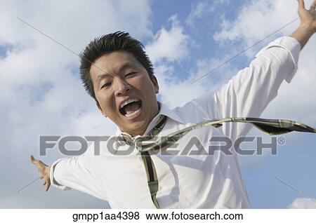 Stock Photo - Asian businessman with arms outstretched. Fotosearch