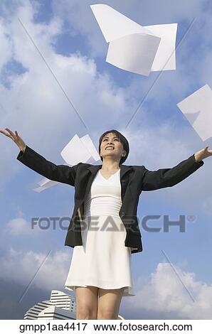 Stock Photo - Asian businesswoman throwing papers in air. Fotosearch