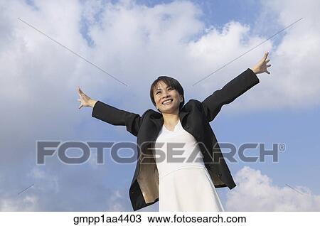 Asian businesswoman with arms outstretched View Large Photo Image Stock Image - Asian businesswoman with arms outstretched. Fotosearch