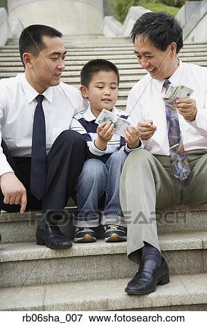 Asian grandfather, father and son looking at money View Large Photo Image Stock Photo - Asian grandfather, father and son looking at money. Fotosearch
