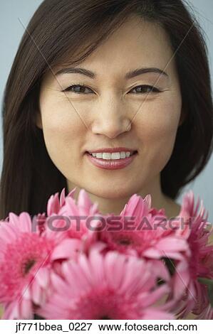 Asian woman and flowers View Large Photo Image Stock Photo - Asian woman and flowers. Fotosearch