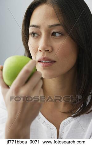 Asian woman eating apple View Large Photo Image Stock Image - Asian woman eating apple. Fotosearch