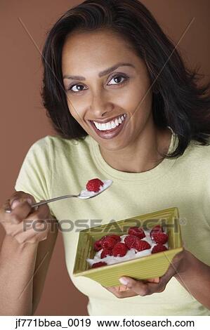 Asian woman eating fruit and cream View Large Photo Image Stock Photo - Asian woman eating fruit and cream. Fotosearch