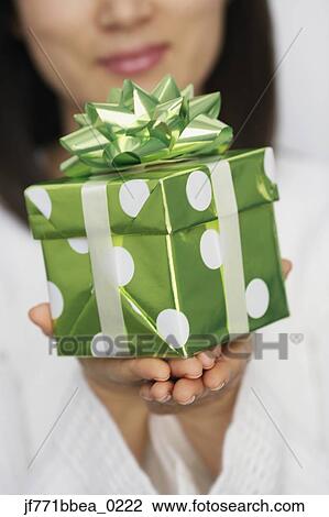 Asian woman holding gift View Large Photo Image Stock Image - Asian woman holding gift. Fotosearch