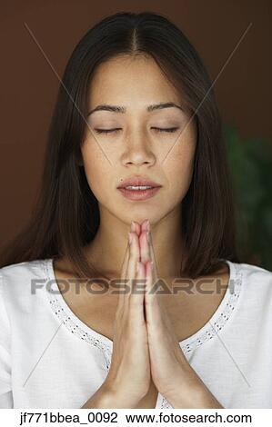 Stock Image - Asian woman meditating. Fotosearch
