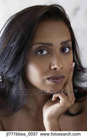 Stock Photo - Asian woman resting chin on hand. Fotosearch