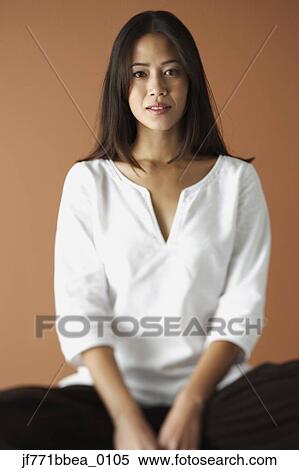 Asian woman sitting cross legged View Large Photo Image Stock Photography - Asian woman sitting cross legged. Fotosearch