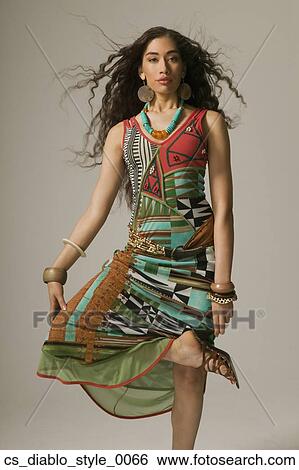 Stock Photograph - Asian woman standing with leg crossed. Fotosearch