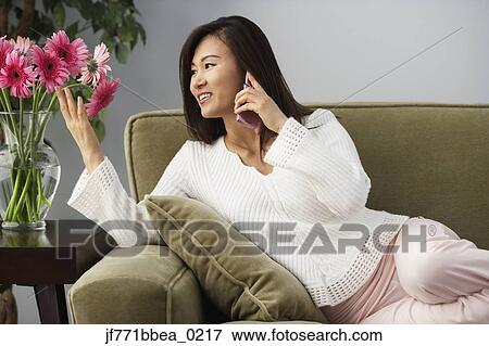 Asian woman talking on cell phone View Large Photo Image Stock Photo - Asian woman talking on cell phone. Fotosearch