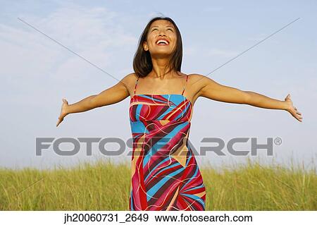 Stock Photo - Asian woman with arms outstretched. Fotosearch