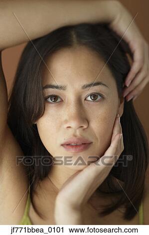 Asian woman with hand on face View Large Photo Image Stock Image - Asian woman with hand on face. Fotosearch