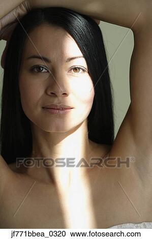 Asian woman with hands on head View Large Photo Image Stock Image - Asian woman with hands on head. Fotosearch