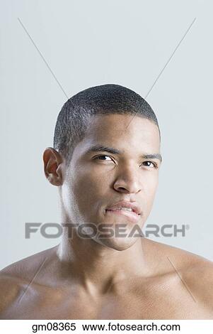 Bare-chested African man biting lip View Large Photo Image Stock Photography - Bare-chested African man biting lip. Fotosearch