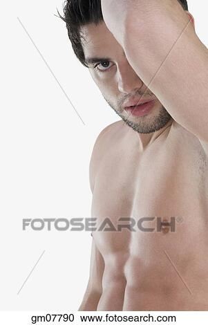 Bare-chested Hispanic man holding arm up View Large Photo Image Stock Image - Bare-chested Hispanic man holding arm up. Fotosearch