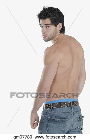 Bare-chested Hispanic man looking over shoulder View Large Photo Image Stock Image - Bare-chested Hispanic man looking over shoulder. Fotosearch
