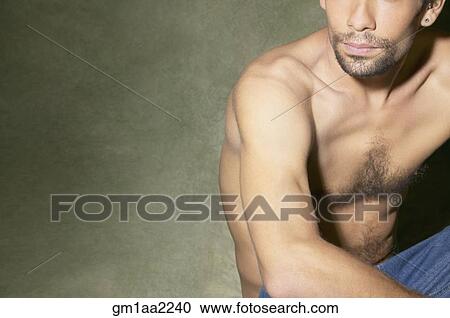 Bare-chested Hispanic man sitting on floor View Large Photo Image Stock Image - Bare-chested Hispanic man sitting on floor. Fotosearch