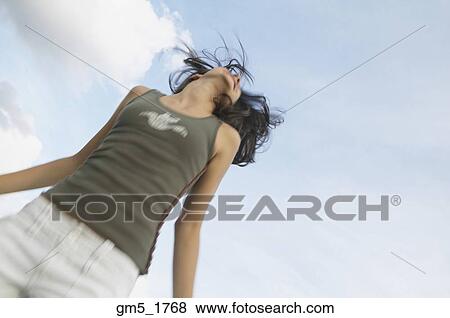 Stock Photo - Blurred shot of Hispanic girl jumping. Fotosearch