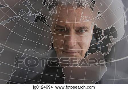 Businessman looking at clear globe View Large Photo Image Picture - Businessman looking at clear globe. Fotosearch