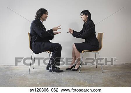 Stock Image - Businesspeople playing rock paper scissors. Fotosearch