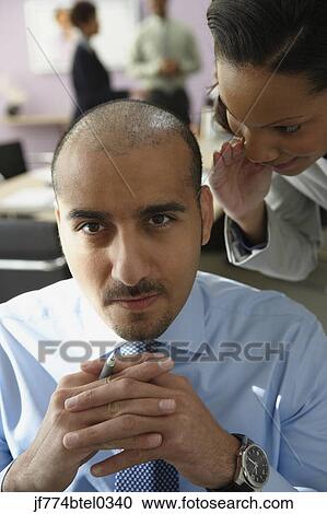Businesswoman telling secret to businessman View Large Photo Image Stock Image - Businesswoman telling secret to businessman. Fotosearch