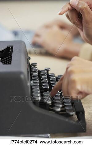Businesswoman typing on typewriter View Large Photo Image Picture - Businesswoman typing on typewriter. Fotosearch