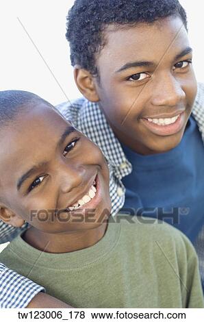 Close up of African brothers hugging View Large Photo Image Stock Photo - Close up of African brothers hugging. Fotosearch