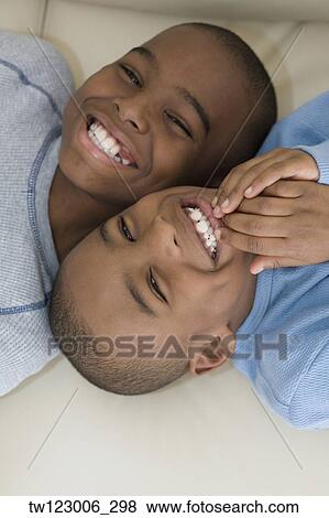 Close up of African brothers smiling View Large Photo Image Stock Photo - Close up of African brothers smiling. Fotosearch