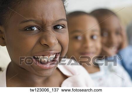 Stock Photo - Close up of African girl making a face. Fotosearch