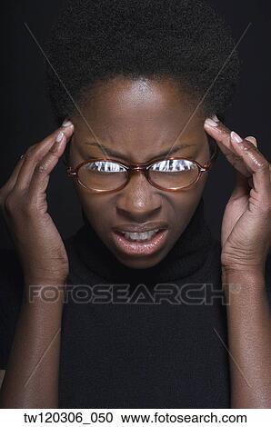 Close up of African woman rubbing temples View Large Photo Image Stock Image - Close up of African woman rubbing temples. Fotosearch