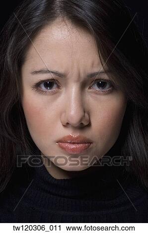 Close up of Hispanic woman furrowing brow View Large Photo Image Stock Image - Close up of Hispanic woman furrowing brow. Fotosearch