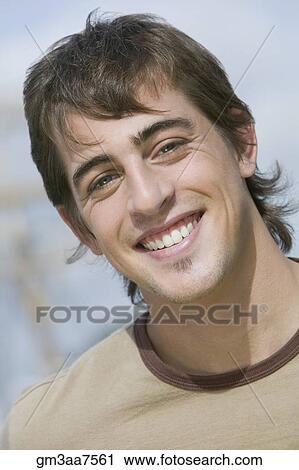 Stock Image - Close up of young man smiling. Fotosearch