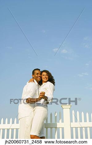 Stock Photo - Couple dancing next to fence. Fotosearch