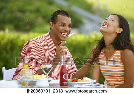 Couple eating at outdoor restaurant View Large Photo Image Stock Photo - Couple eating at outdoor restaurant. Fotosearch