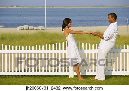 Couple holding hands at beach View Large Photo Image Stock Image - Couple holding hands at beach. Fotosearch