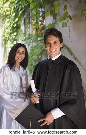 Graduating man and woman holding diplomas View Large Photo Image Stock Photography - Graduating man and woman holding diplomas. Fotosearch