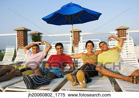 Group of friends in lounge chairs View Large Photo Image Stock Photography - Group of friends in lounge chairs. Fotosearch