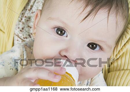 Stock Photo - Hispanic baby drinking from bottle. Fotosearch