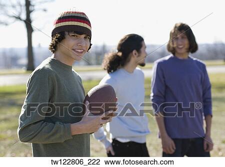 Hispanic boy holding football outdoors View Large Photo Image Stock Image - Hispanic boy holding football outdoors. Fotosearch
