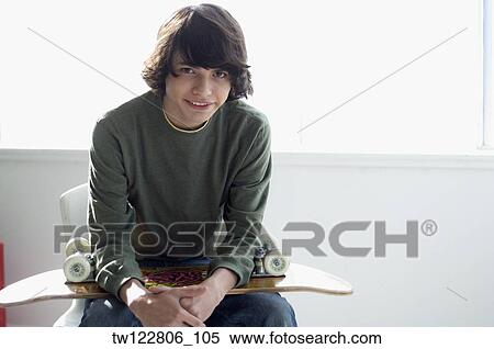 Hispanic boy holding skateboard View Large Photo Image Stock Photography - Hispanic boy holding skateboard. Fotosearch