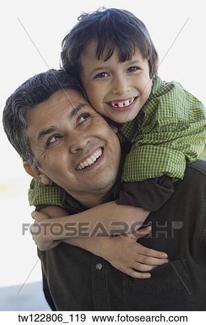 Stock Photo - Hispanic boy hugging father. Fotosearch